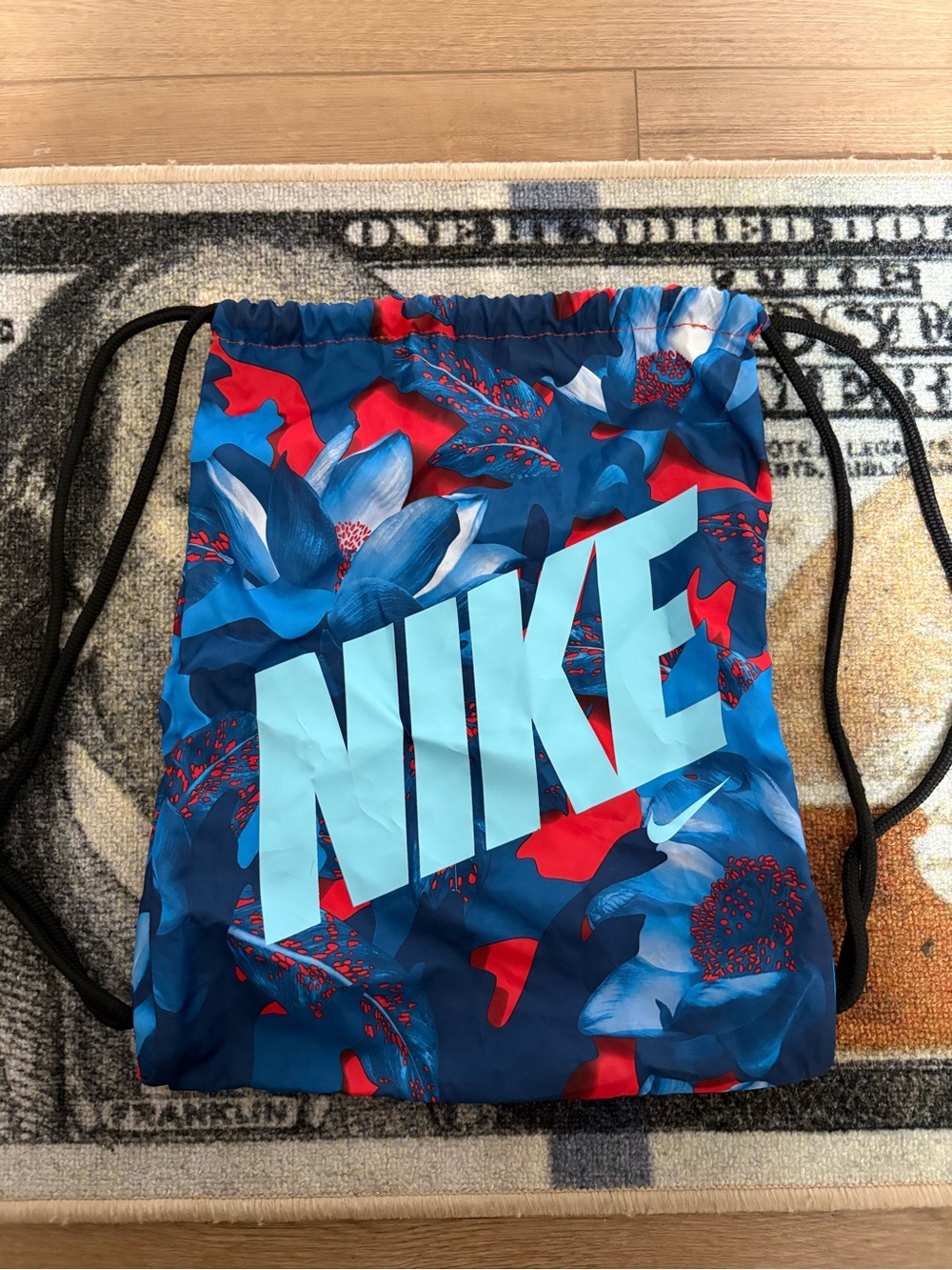 Nike Blue Floral Drawstring Backpack with Light Blue Logo and Red Accents